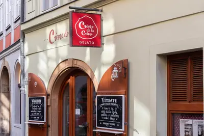 a restaurant with a sign on the side of a building at 6 Continents Apartments by Adrez in Prague