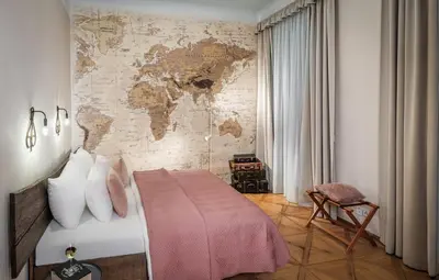 a bedroom with a map of the world on the wall at 6 Continents Apartments by Adrez in Prague