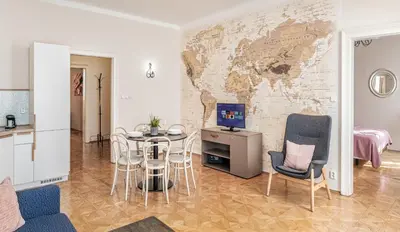 a living room with a table and a map on the wall at 6 Continents Apartments by Adrez in Prague