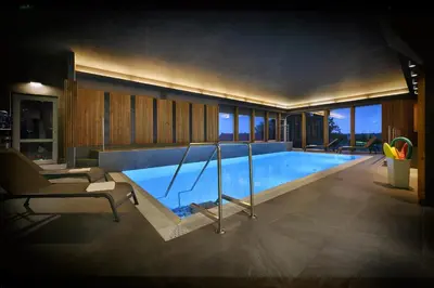 a large swimming pool in a house at Maxmilian Lifestyle Resort in Loučeň