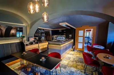 a restaurant with red chairs and tables in a room at Maxmilian Lifestyle Resort in Loučeň