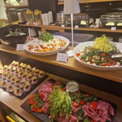 a buffet of different types of food on display at Maxmilian Lifestyle Resort in Loučeň