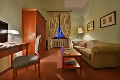 a living room with a couch and a chair at Maxmilian Lifestyle Resort in Loučeň