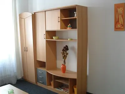a book shelf with a vase on it in a room at Nice Apartments Prague in Prague