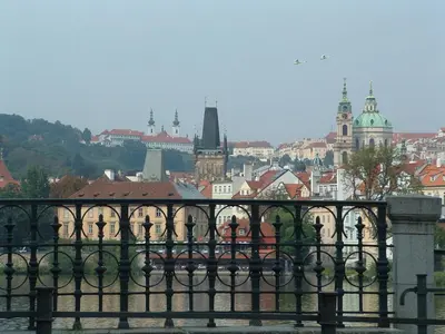 a view of a city from behind a fence at Nice Apartments Prague in Prague