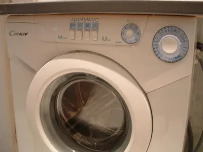 a washing machine is sitting in a room at Nice Apartments Prague in Prague