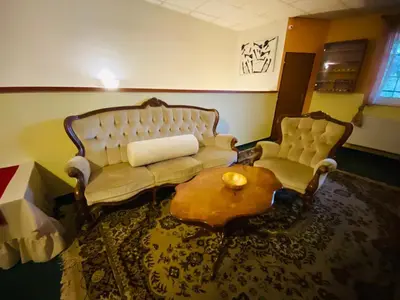 a living room with a couch and two chairs at Hotel Swami in Mělník