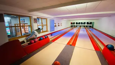 a bowling alley with a person playing bowling at Hotel Swami in Mělník