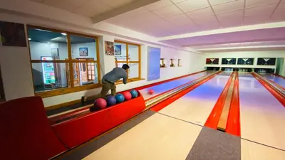 a man playing bowling in a bowling alley at Hotel Swami in Mělník