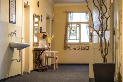 a hallway with a sink and a window at Hostel Dakura in Prague