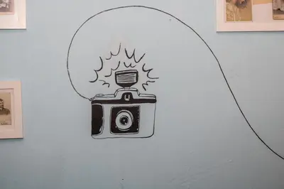 a drawing of a camera on a wall at Hostel Dakura in Prague