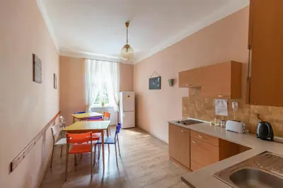 a kitchen with a table and chairs in a room at Hostel Dakura in Prague