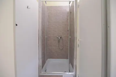 a shower in a bathroom with a glass door at Hostel Dakura in Prague