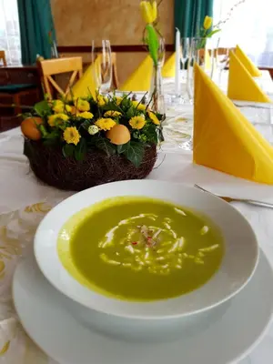 a bowl of soup sitting on a table with a plate at Hotel U Berounky in Srbsko