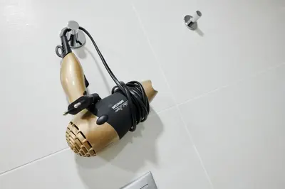 a hair dryer hanging on a wall in a bathroom at Residence Nad Vltavou in Prague