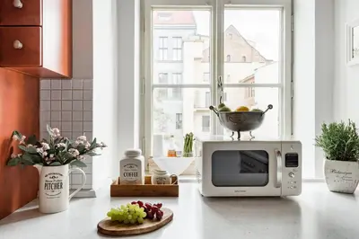 a kitchen with a microwave and a bowl on top of it at Old Town Square Apartment in Prague