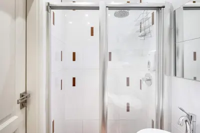 a shower with a glass door in a bathroom at Old Town Square Apartment in Prague