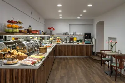 a large kitchen with a counter with food on it at Hotel Taurus in Prague
