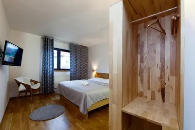 a small bedroom with a bed and a shower at Hotel Wolf in Prague
