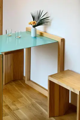 a table with two glasses and a potted plant on it at Hotel Wolf in Prague
