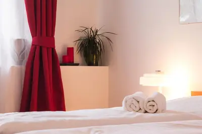 a bedroom with a bed with towels on it at Hotel Wolf in Prague