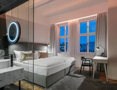 a hotel room with a bed and a desk and a bedroom at Pytloun Boutique Hotel Prague in Prague