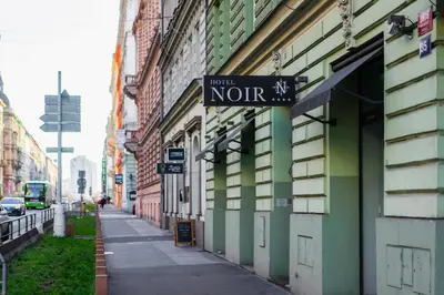 a street sign on the side of a building at Hotel Noir in Prague
