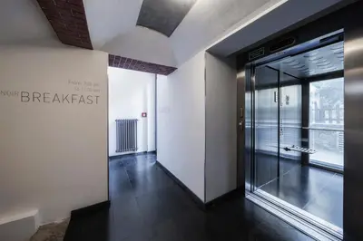 a hallway with a glass door in a building at Hotel Noir in Prague