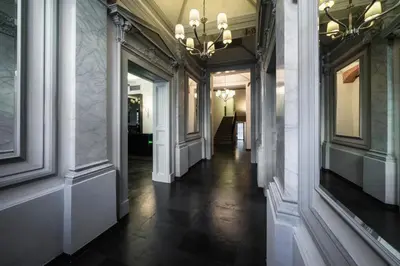 a hallway of a building with a chandelier at Hotel Noir in Prague