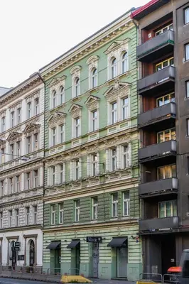 a green building on the side of a street at Hotel Noir in Prague