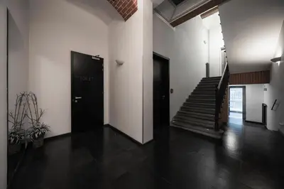 a hallway with two black doors and a staircase at Hotel Noir in Prague