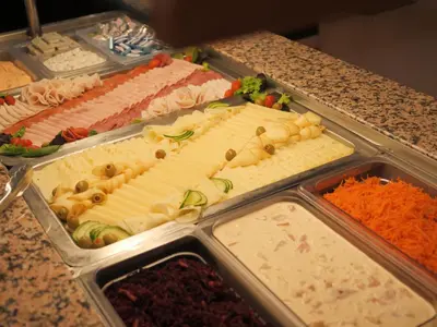 a buffet of different types of food on a counter at Abitohotel in Prague