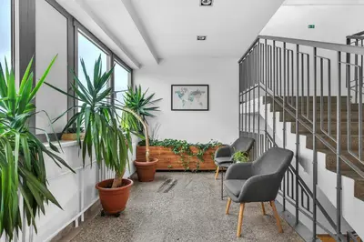 a room with two chairs and potted plants at Abitohotel in Prague