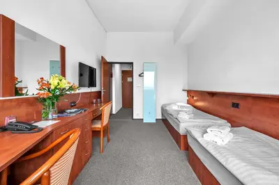 a hospital room with two beds and a mirror at Abitohotel in Prague