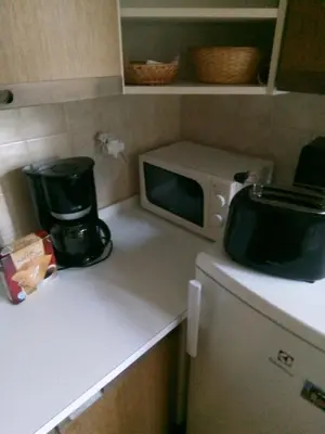 a small kitchen with a microwave and a counter top at apartricanova in Prague