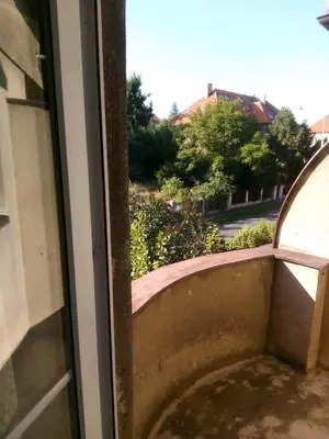 a window with a view of a street at apartricanova in Prague