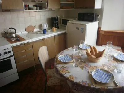 a kitchen with a table with plates and wine glasses at apartricanova in Prague