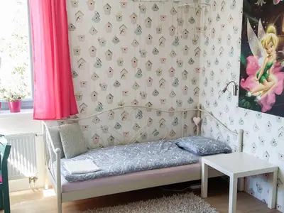 a childs bedroom with a bed and a table at Holiday Home Řeporyje by Interhome in Prague