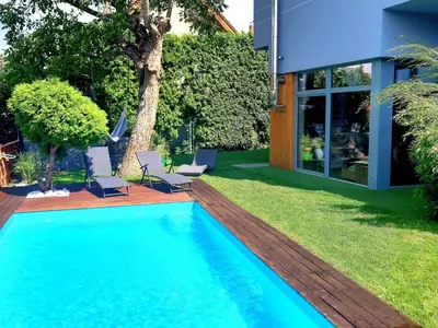 a swimming pool in the yard of a house at Holiday Home Řeporyje by Interhome in Prague
