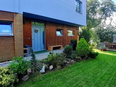 a house with a blue door and a yard at Holiday Home Řeporyje by Interhome in Prague