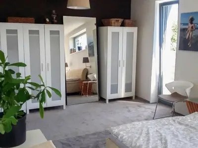 a bedroom with white cabinets and a mirror at Holiday Home Řeporyje by Interhome in Prague