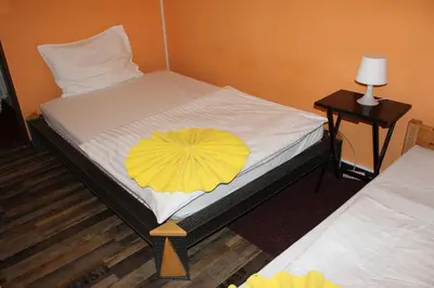a room with a bed with a yellow umbrella on it at Hotel Praha Club bed & breakfast in Prague