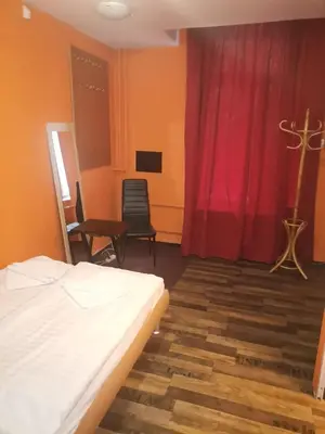 a bedroom with a bed and a table and chairs at Hotel Praha Club bed & breakfast in Prague