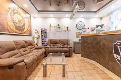 a living room with a couch and two chairs at Hotel Wilhelm in Prague