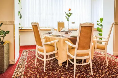 a dining room with a table and chairs at Hotel Ostrov in Nymburk