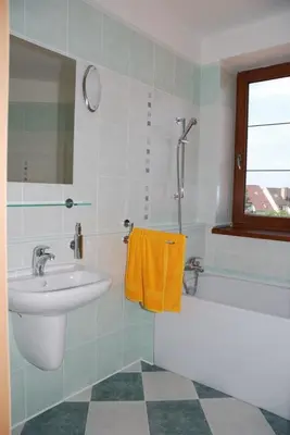 a bathroom with a sink and a bath tub and a sink at Hotel Ostrov Garni in Sadská