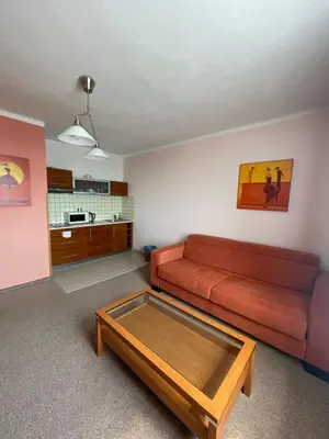 a living room with a couch and a coffee table at Hotel Ostrov Garni in Sadská