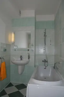 a bathroom with a bath tub and a sink at Hotel Ostrov Garni in Sadská