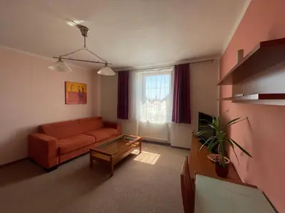 a living room with a couch and a window at Hotel Ostrov Garni in Sadská