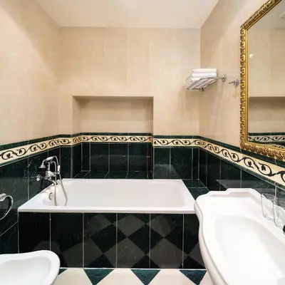 a bathroom with a tub and a sink and a mirror at Boutique Hotel Bijou de Prague in Prague